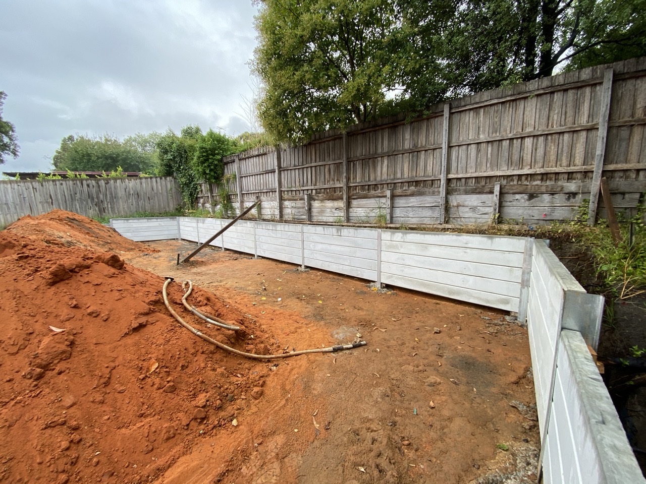 Concrete sleeper retaining wall under construction